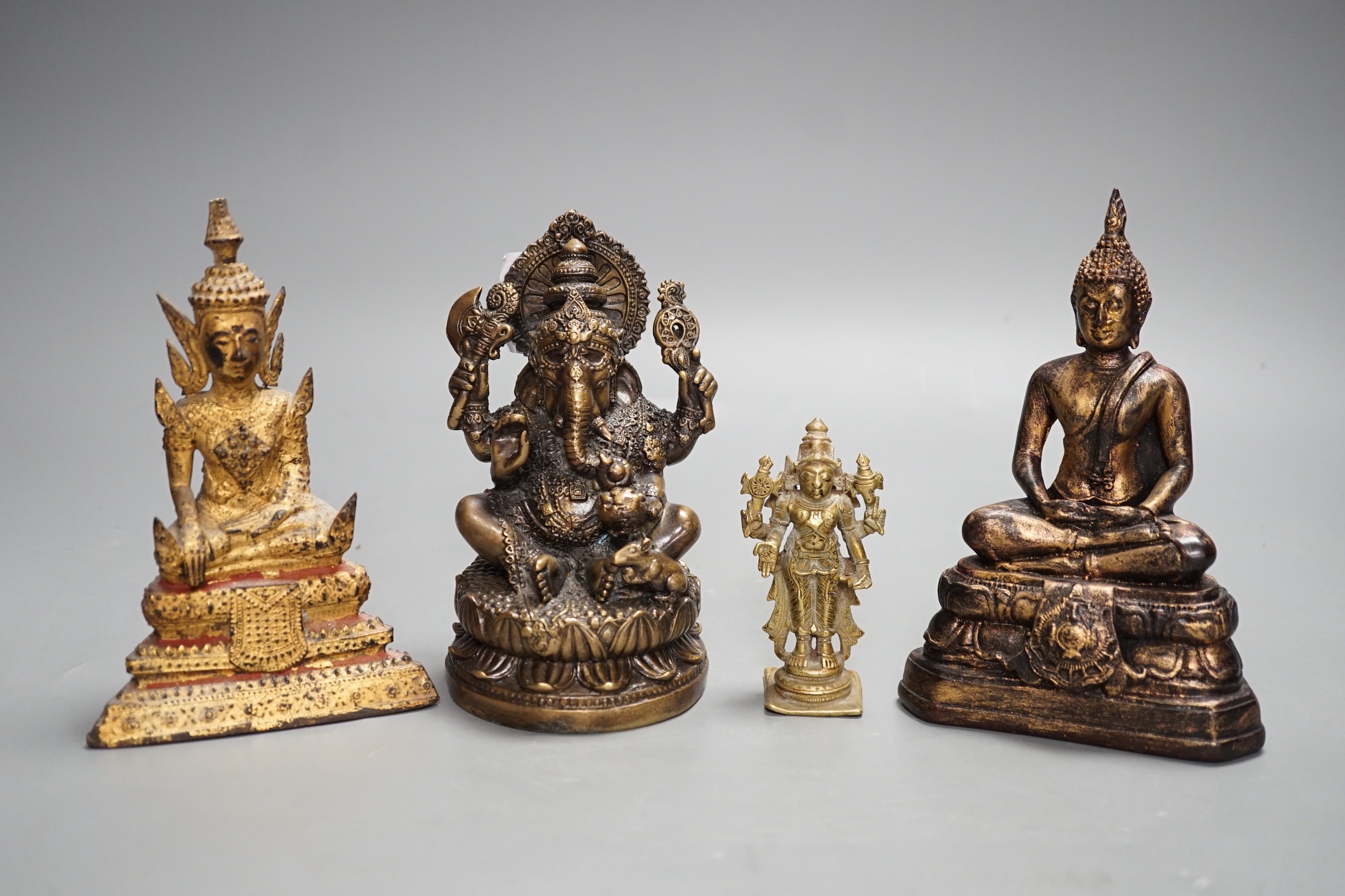A Thai gilt resin model of Buddha, an Indian bronze model of Ganesh, a jadeite coloured carving of Guanyin and two other figures. Tallest 30cm